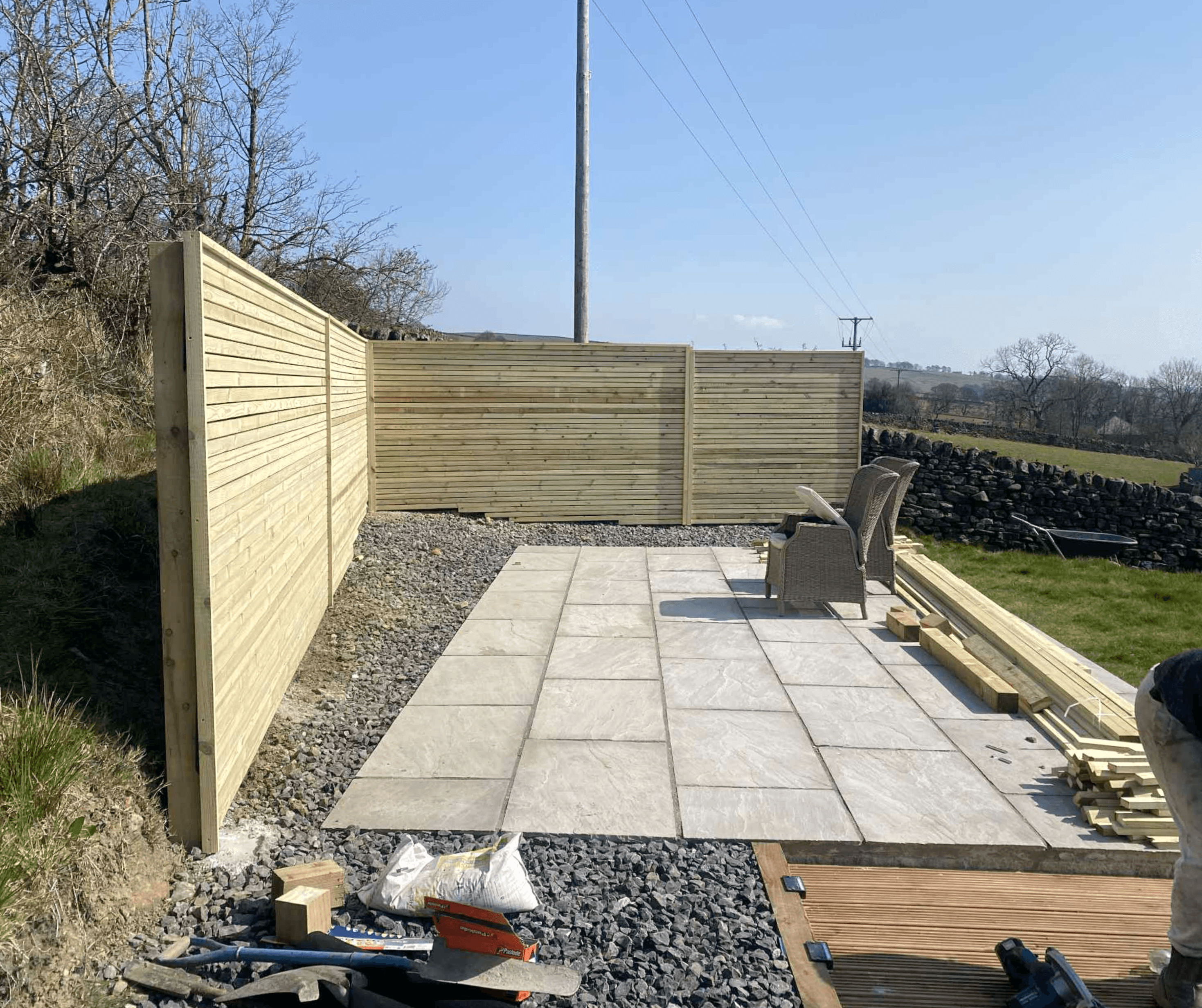 Slab patio with a timber screen fence and gravel border