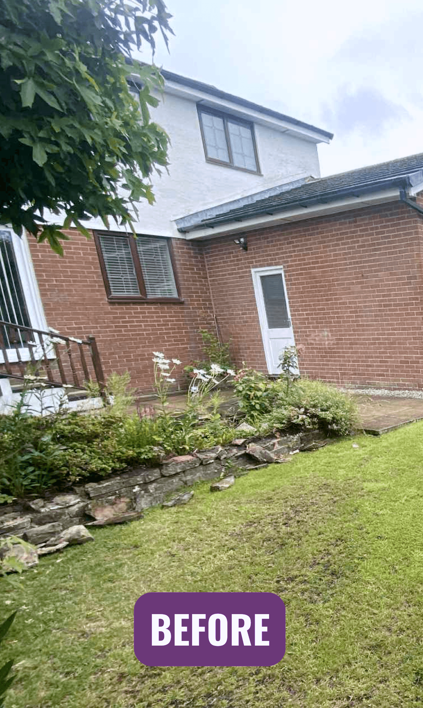 Before: an uneven rear garden with a rockery border